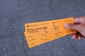 Hand holding pair of ferry tickets to St John`s Island which is popular with locals and tourists Royalty Free Stock Photo