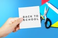 Hand holding paper with Back to school text Royalty Free Stock Photo
