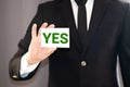 Hand holding a paper card with the word YES Royalty Free Stock Photo