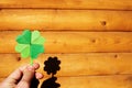 Hand holding paper origami green shamrock