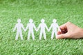 Hand Holding Paper People Chain On Grass Royalty Free Stock Photo