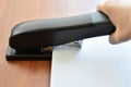 Hand holding paper stapler with paper Royalty Free Stock Photo