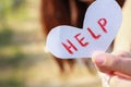 Hand holding the paper writing the word help Royalty Free Stock Photo