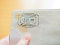 Hand holding passport with Australian immigration stamp Royalty Free Stock Photo