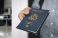 hand holding passport with bokeh background, jorney and travel concept. Passport check at the border. A man will find a passport