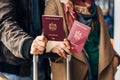 Couple Hand holding Passport . Traveler with Luggage Travel concept. People tourism. Biometric Moldavian passports