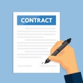 Hand holding pen to sign contract.