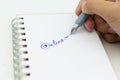 Hand holding pen and write text `online`. Image use for network, internet, business concept Royalty Free Stock Photo