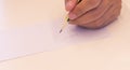 Hand holding a pencil  on white background . Close Up on a man`s hand writing on paper with a pencil  .Planning business Royalty Free Stock Photo