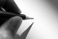 Hand holding pencil to write on the paper in shadow Royalty Free Stock Photo