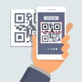 Hand holding phone with app for scanning QR code