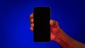 Hand Holding Phone With Blank Screen Over Blue Background, Panorama Royalty Free Stock Photo