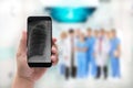 Hand holding a phone with chest x-ray image and Doctor leading a Royalty Free Stock Photo