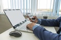 hand holding phone mockup image blank screen computer laptop for advertising text in workplace desk in office. copy Royalty Free Stock Photo