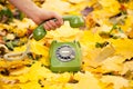 Hand holding phone receiver in autumn park Royalty Free Stock Photo