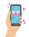 Hand holding the phone to which came a love message. Royalty Free Stock Photo