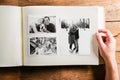 Hand holding photo album with pictures of senior couple. Studio Royalty Free Stock Photo