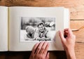 Hand holding photo album with pictures of senior couple. Studio Royalty Free Stock Photo