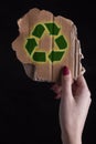 Hand holding a piece of  Cardboard With Recycle Symbol Royalty Free Stock Photo