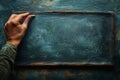 Hand holding a piece of chalk writing on a blackboard Royalty Free Stock Photo