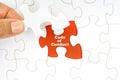 Hand holding piece of jigsaw puzzle with word CODE OF CONDUCT