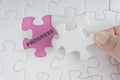 Hand holding piece of jigsaw puzzle with word PROGRESS. Royalty Free Stock Photo