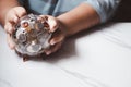 Hand holding piggy bank. Clear glass material. Money saving concept Royalty Free Stock Photo