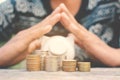 Hand holding piggy bank and coin on old wood Royalty Free Stock Photo