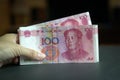 Hand holding a pile of 100 Chinese yuan bank notes Royalty Free Stock Photo
