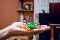 Hand holding pile of colorful coated candy