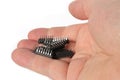 Hand holding a pile of integrated circuit chips. Electronic components.