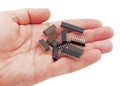 Hand holding a pile of integrated circuit chips