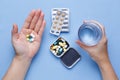 Hand holding pills and glass of water Royalty Free Stock Photo
