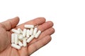 Hand holding pills isolated on white background Royalty Free Stock Photo