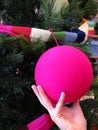 Hand holding pink Christmas ball Royalty Free Stock Photo