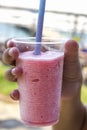 Hand holding pink cocktail with crushed ice - strawberry frappe Royalty Free Stock Photo