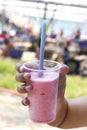 Hand holding pink cocktail with crushed ice - strawberry frappe Royalty Free Stock Photo