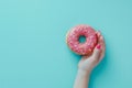 Hand Holding Pink Donut With Sprinkles Royalty Free Stock Photo