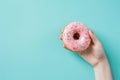 Hand Holding Pink Donut With Sprinkles Royalty Free Stock Photo