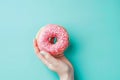 Hand Holding Pink Donut With Sprinkles Royalty Free Stock Photo