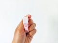 hand holding a pink patient bracelet  on a white background Royalty Free Stock Photo