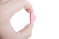 Hand holding pink pill Royalty Free Stock Photo