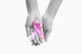 Hand holding pink ribbon on hand, isolated on white background. Symbolic of breast cancer awareness Royalty Free Stock Photo