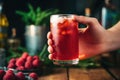 hand holding a pint glass filled with raspberry-infused beer Royalty Free Stock Photo