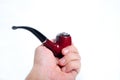 Hand holding pipe Royalty Free Stock Photo