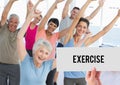 Hand holding placard that reads exercise against people doing aerobics Royalty Free Stock Photo