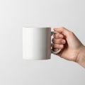 Hand holding a plain white ceramic mug Royalty Free Stock Photo