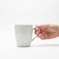 Neatly manicured nails, is positioned on the right side of the mug, Royalty Free Stock Photo