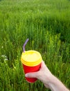 Hand holding plastic cup