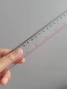 A hand is holding a plastic ruler Royalty Free Stock Photo